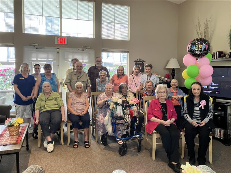 Multiple seniors sitting together celebrating the 103rd birthday of a resident.