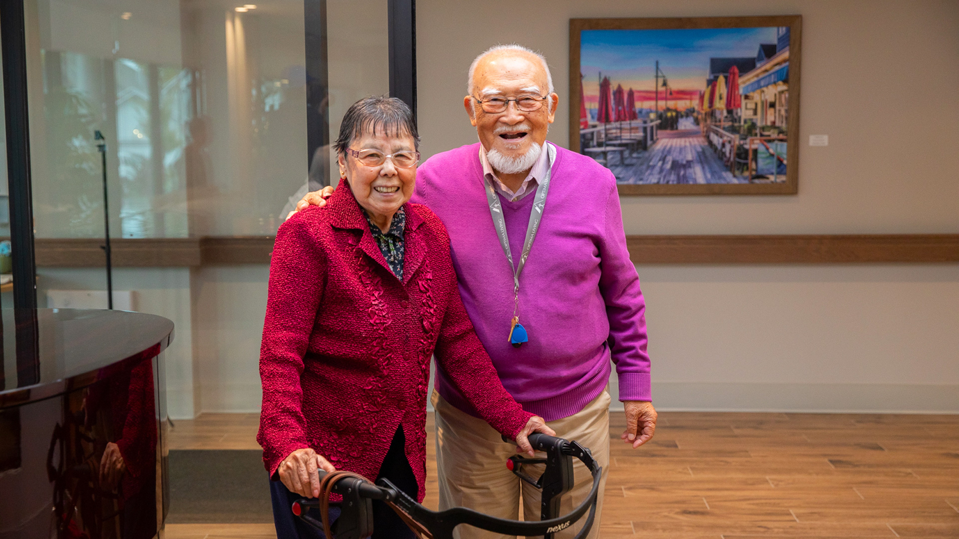 Senior couple standing beside a walker