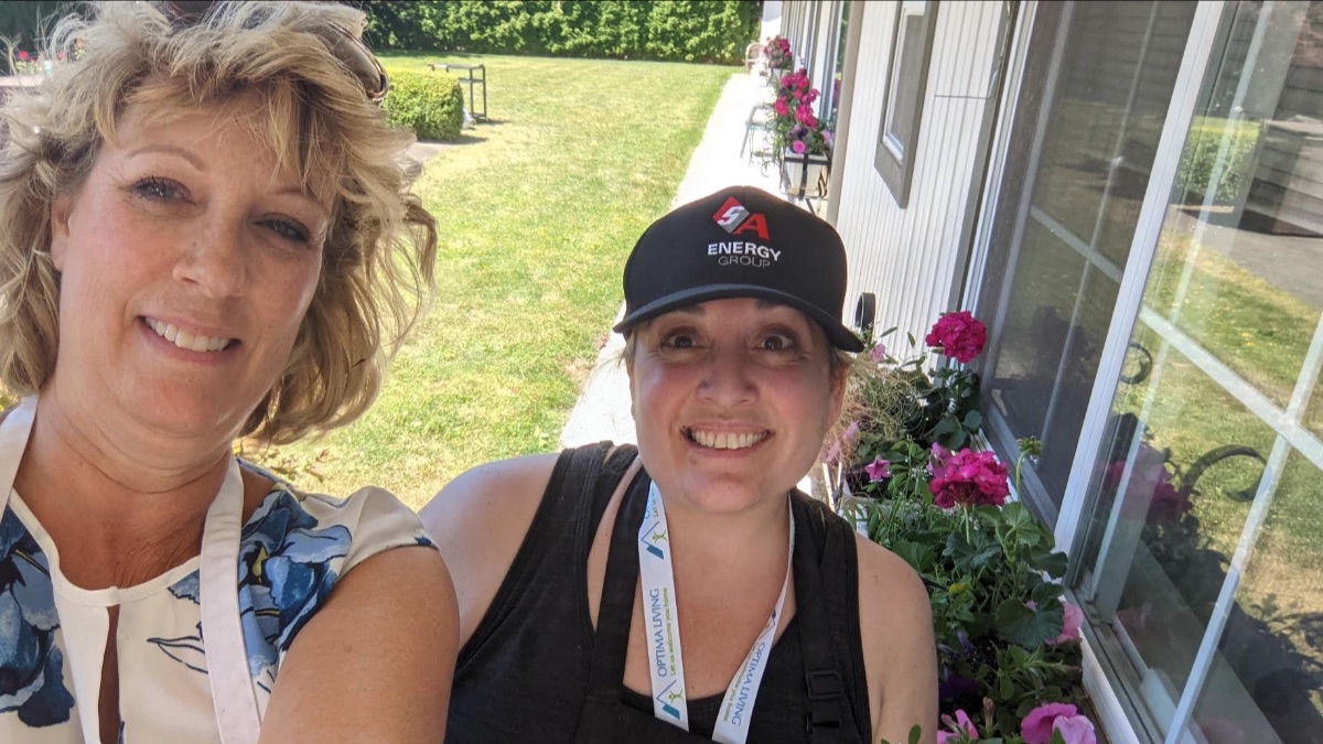 A picture of two ladies in a garden