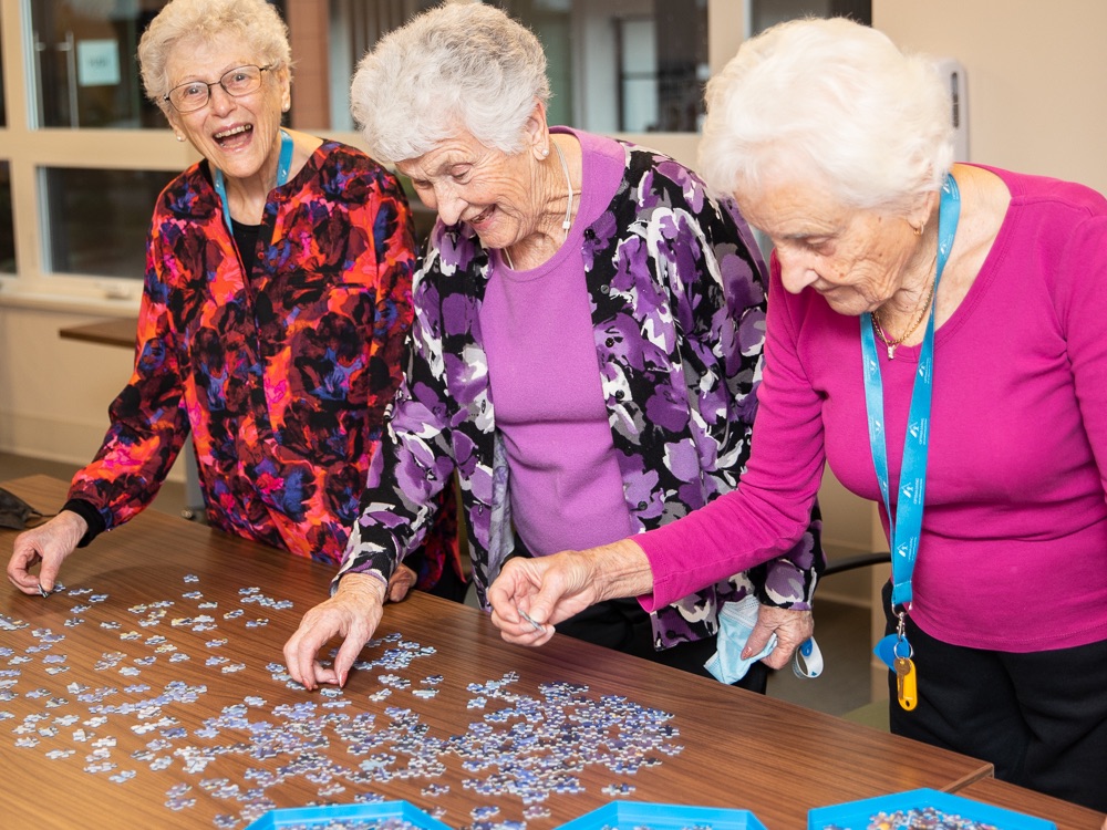Women participating in hobbies for elderly, a puzzle