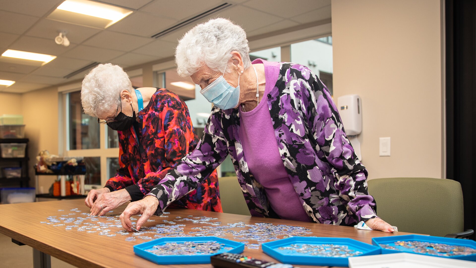 Two elder ladies playing puzzle