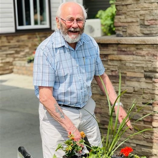 A senior man gardening outside Wild Rose senior living communities