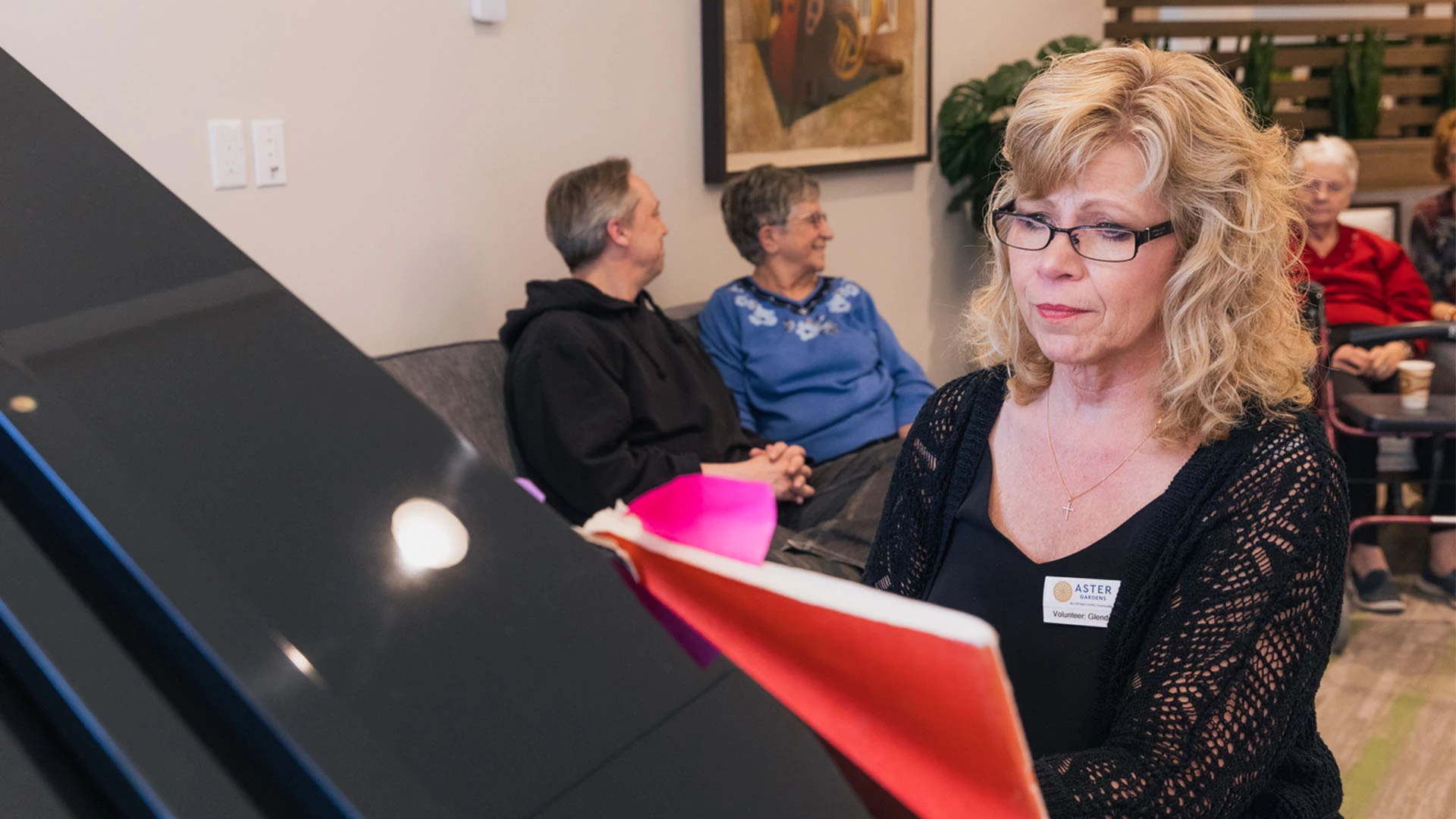 Aster Gardens staff member playing piano
