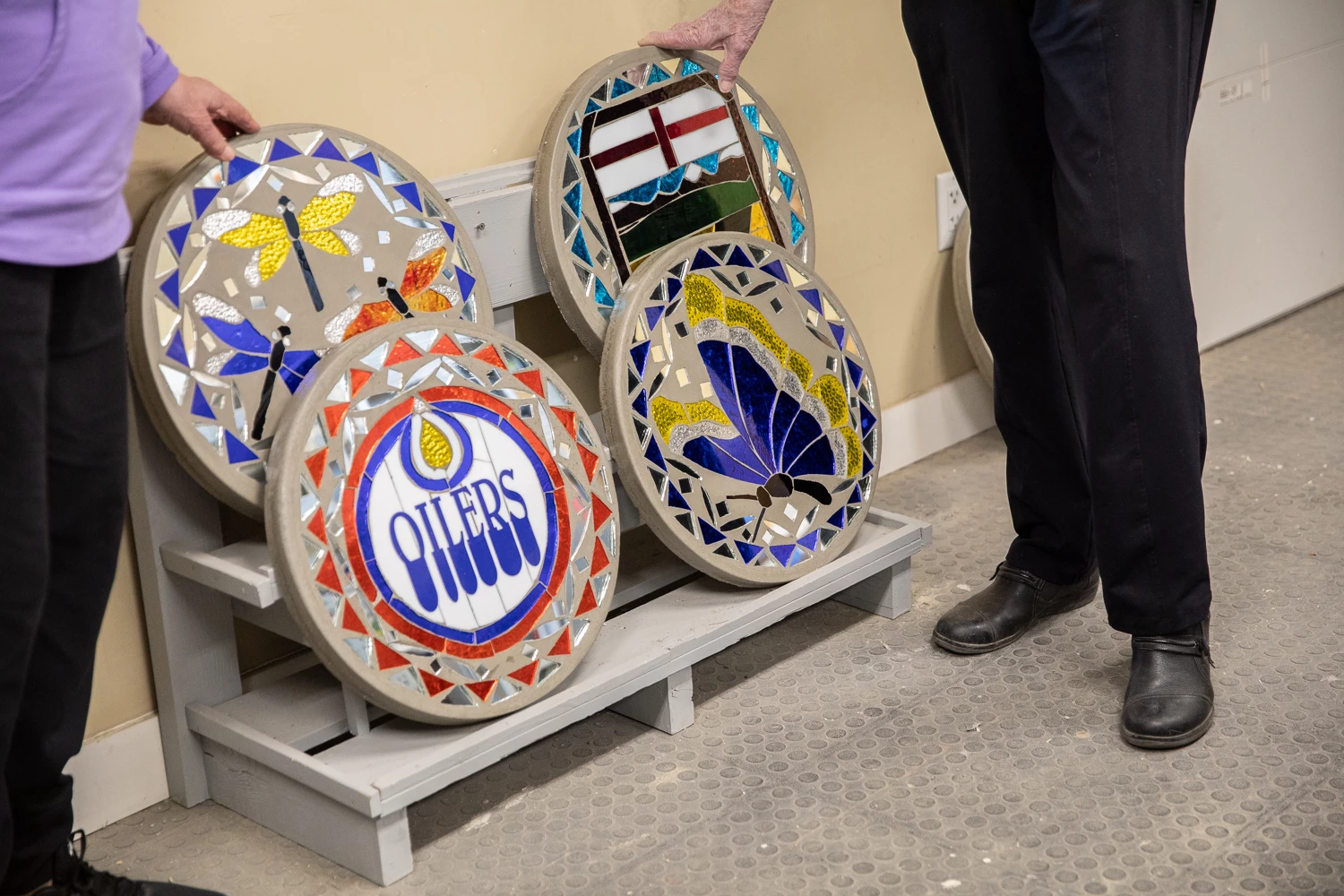 Nel showing off four of her finished plaques