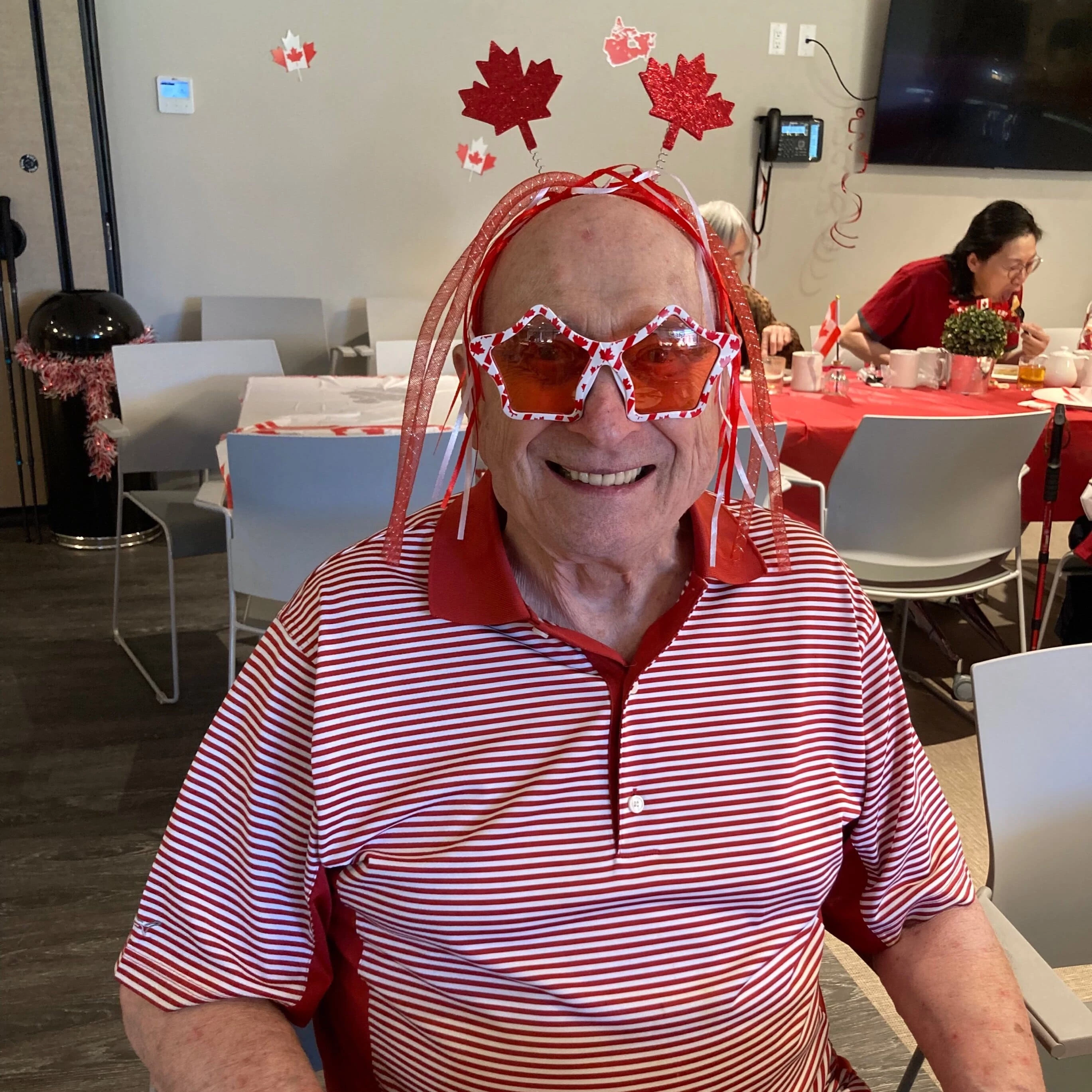 A senior man wearing red and white on Canada Day in his senior apartment residence