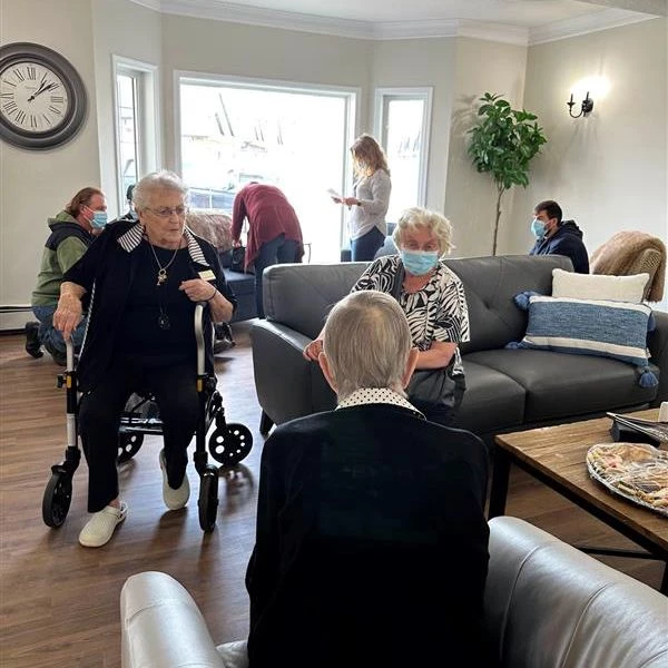 Multiple seniors seated in Country Cottage and talking with one another