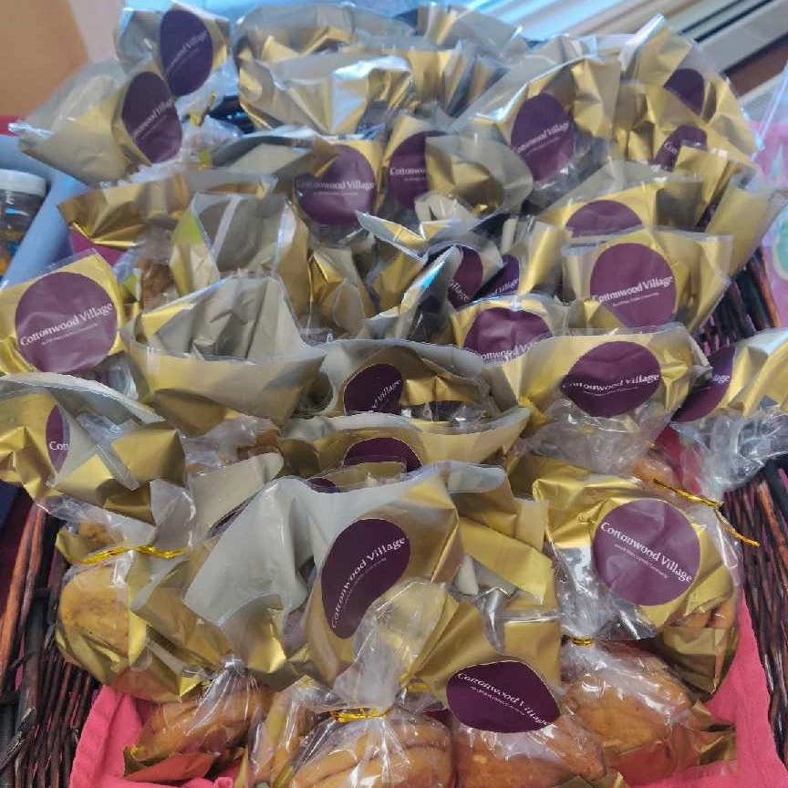 Cookies wrapped in plastic from the Cottonwood Village open house. All cookies have a Cottonwood Village sticker on top of the plastic.