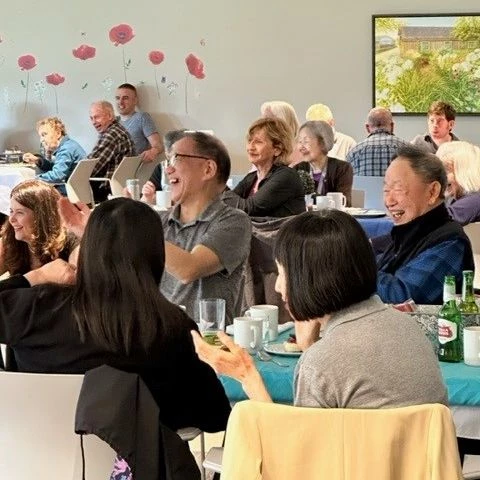 Seniors laughing at a meal together