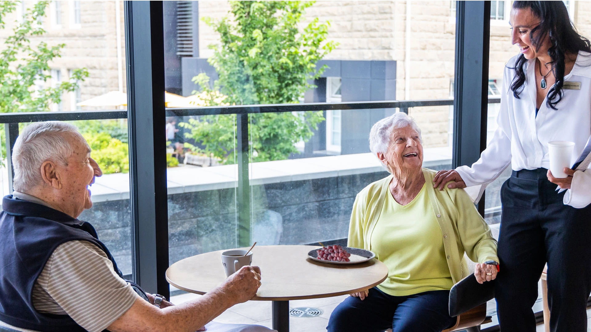 A young woman talking to a senior couple