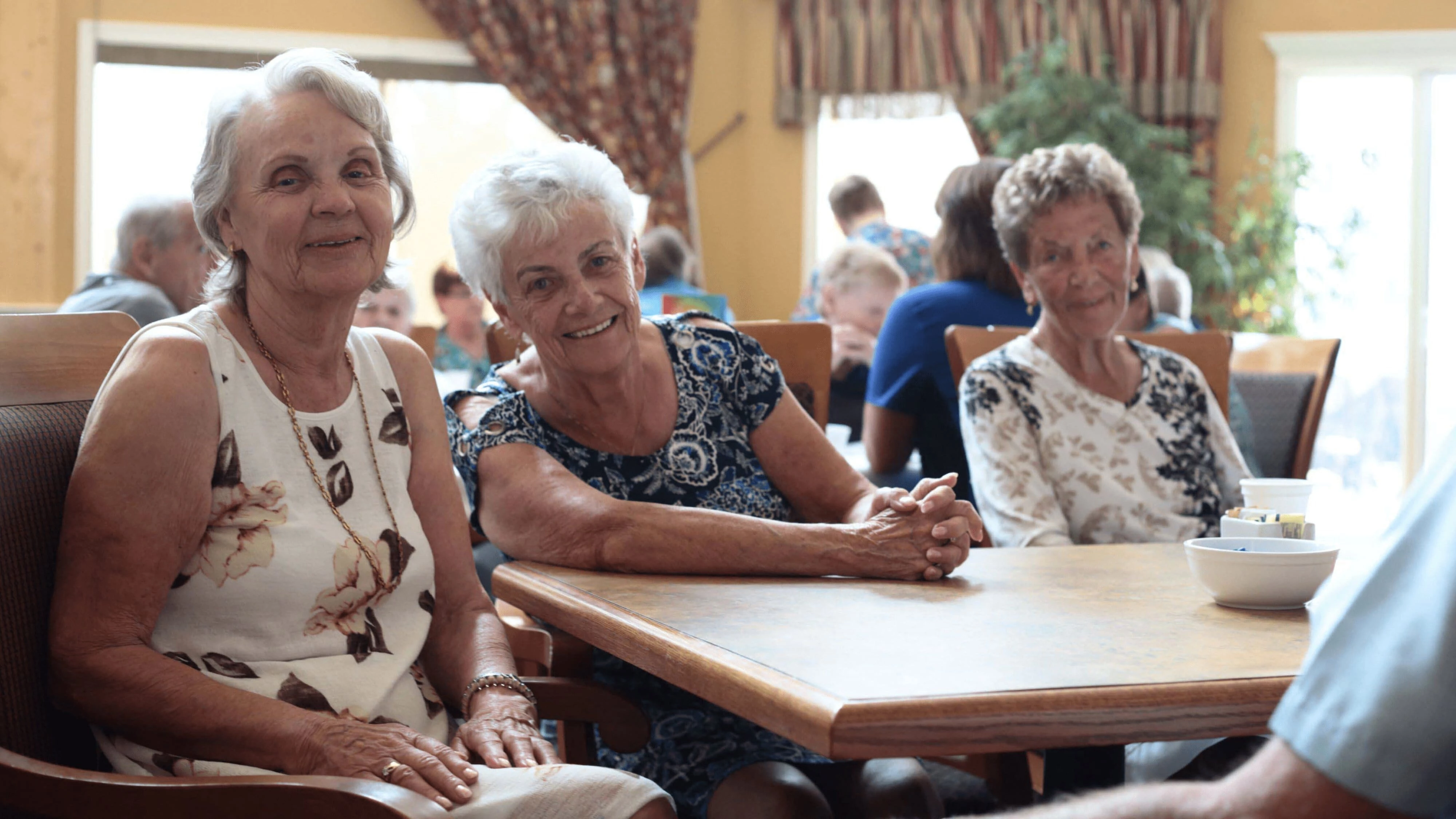 At Cottonwood Village, a group of senior women are having lunch.