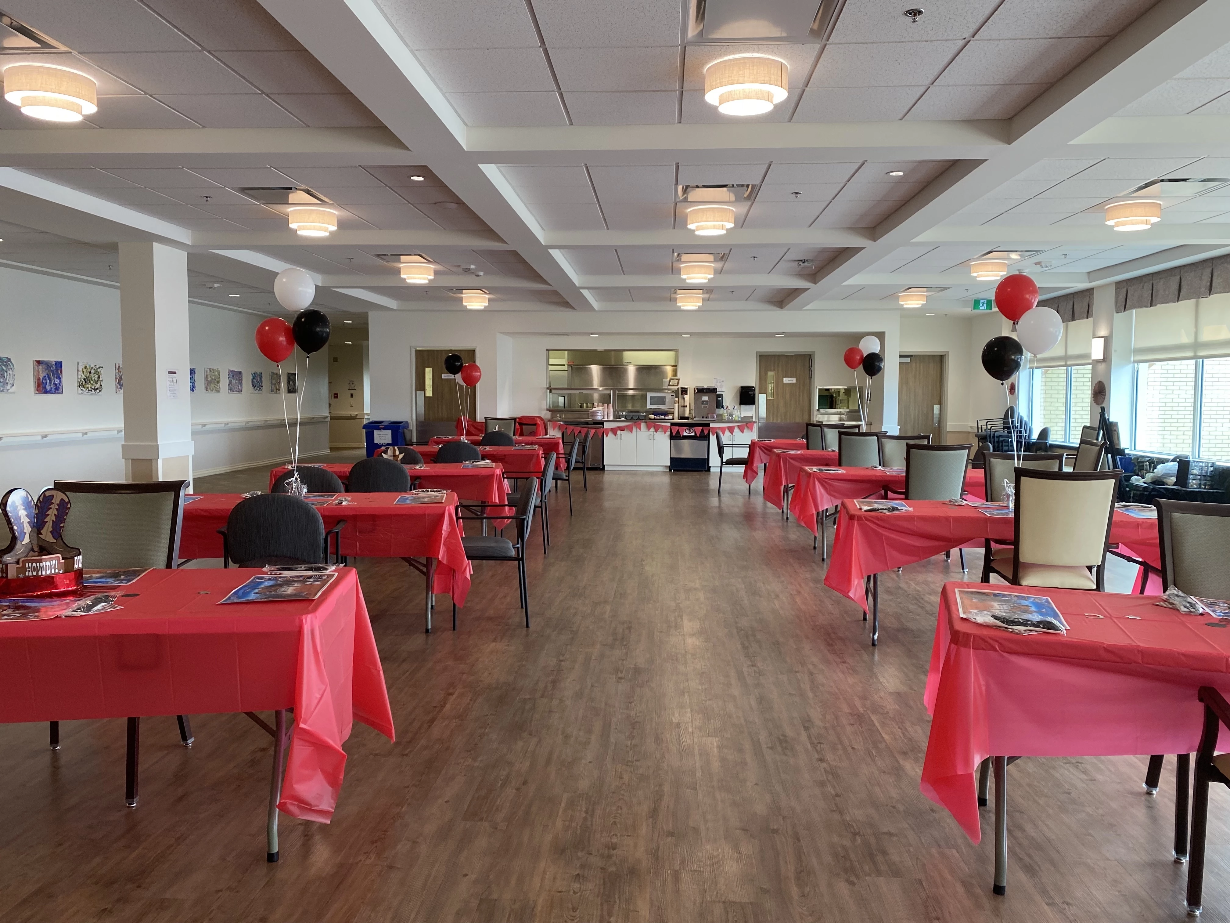 A large common area with a lot of table with red clothes