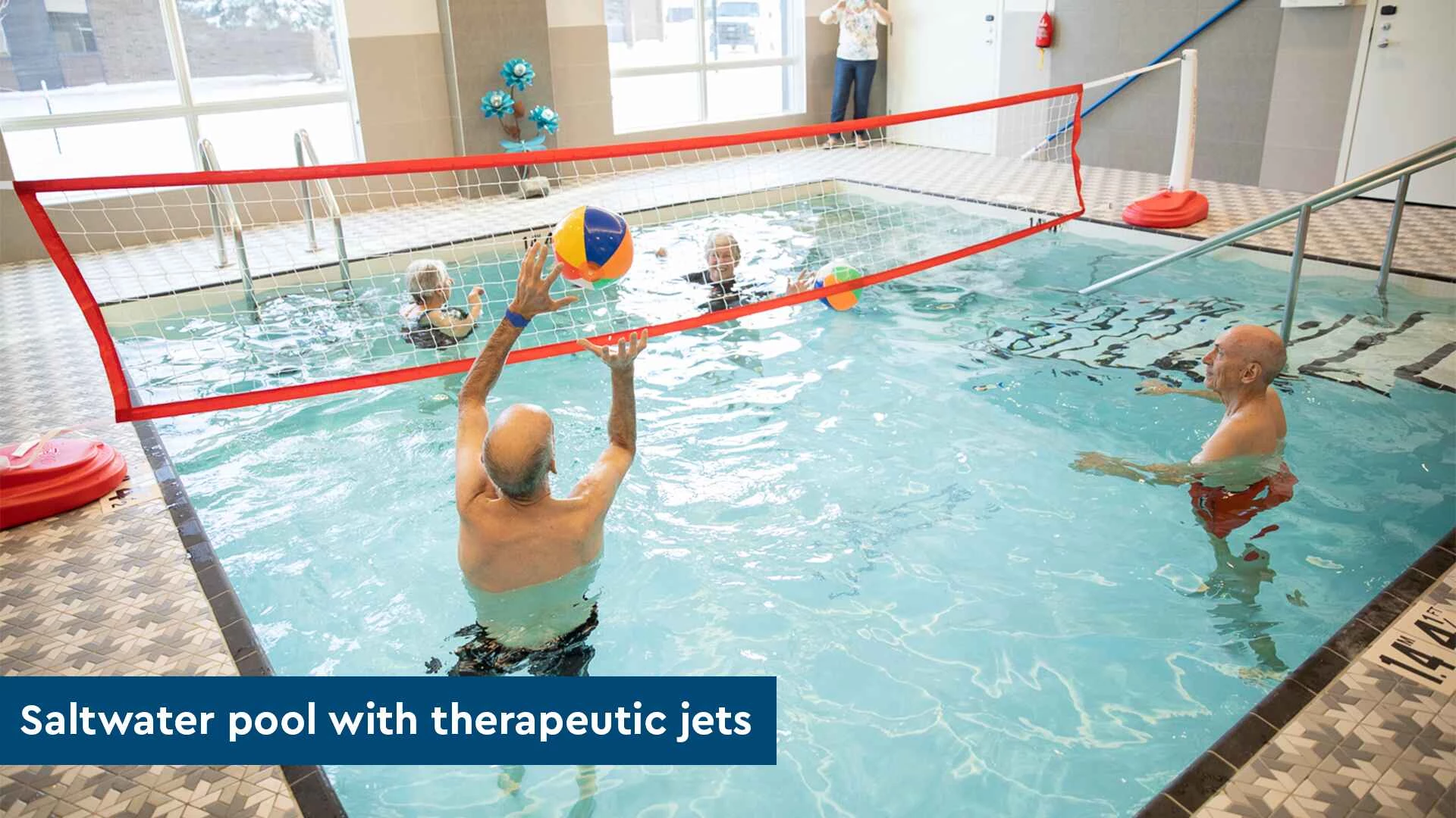 A group of senior citizens playing volleyball in pool