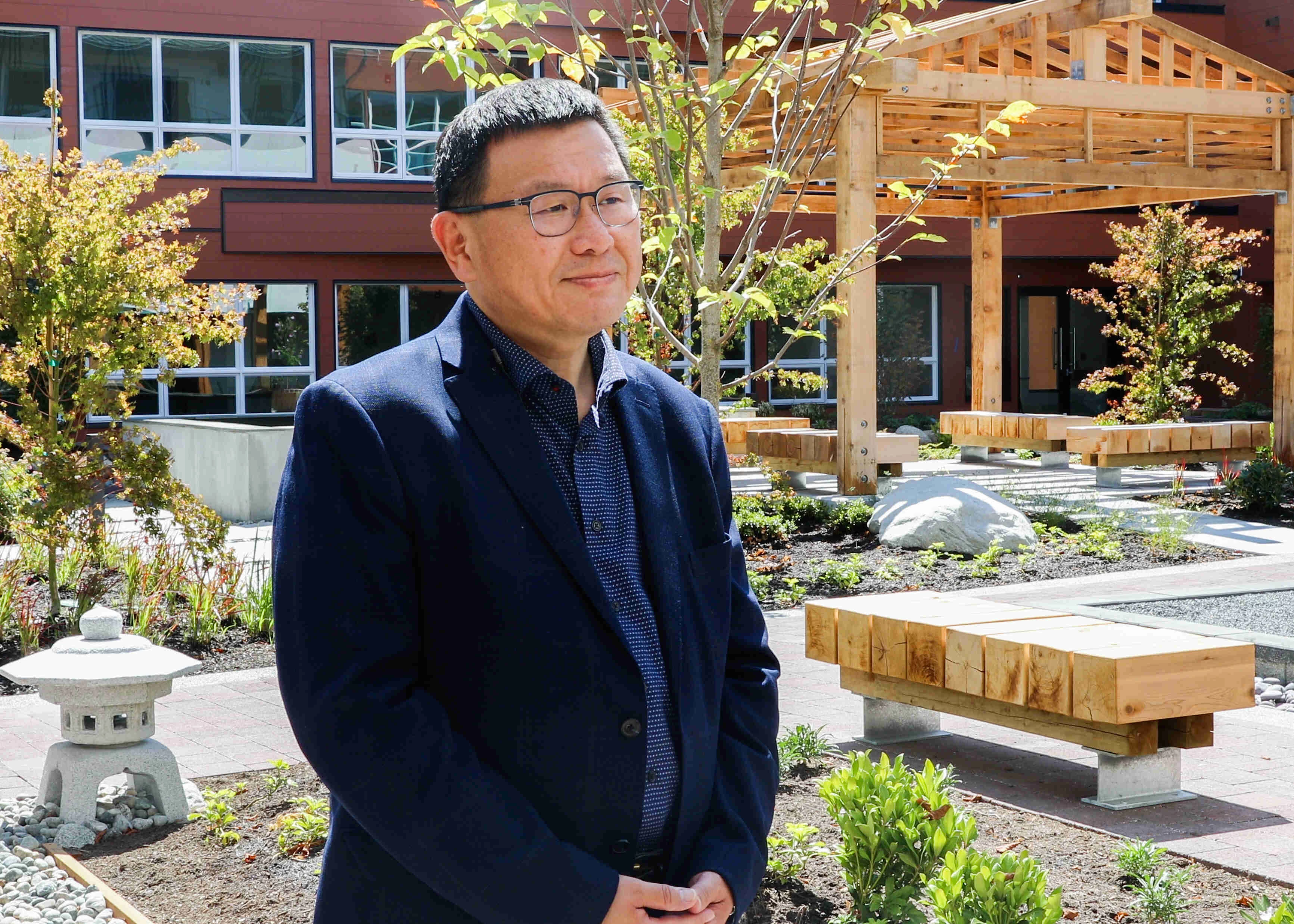 A man standing in front of Wisteria place