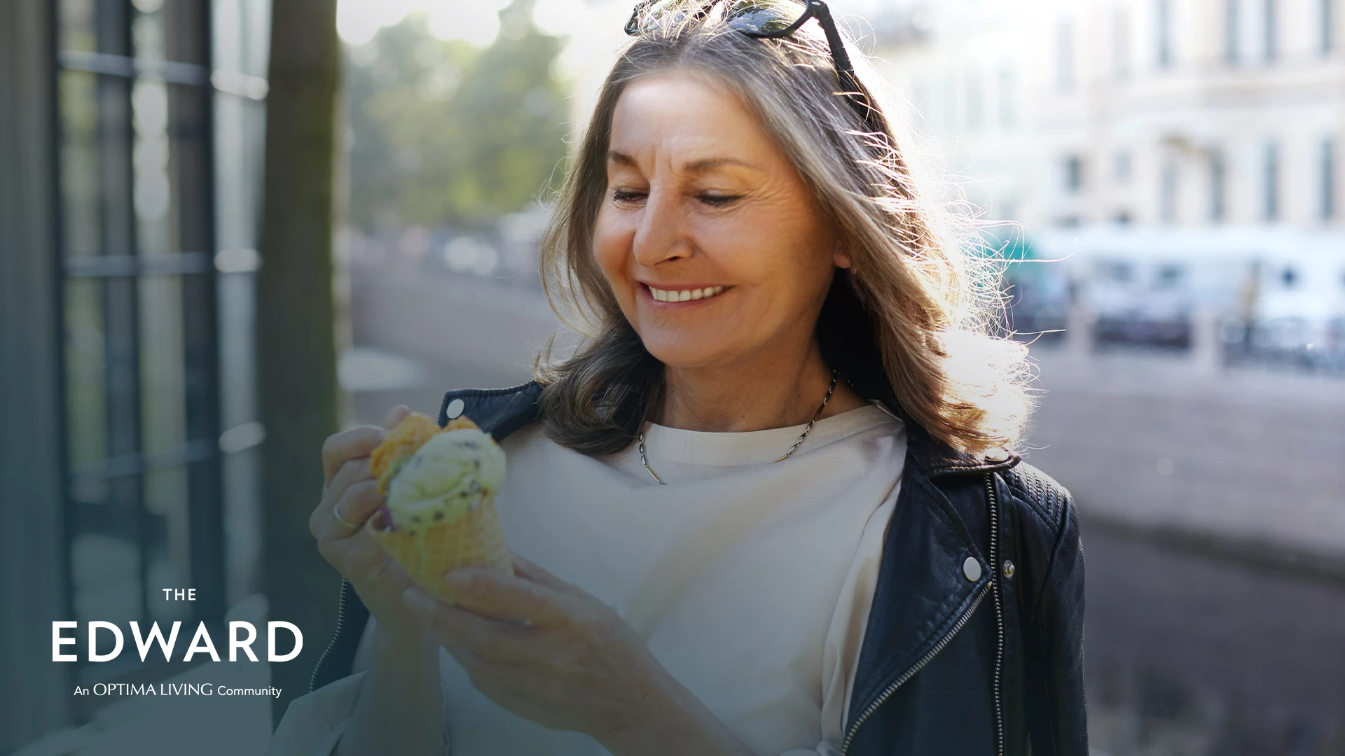 Smiling lady eating ice cream outside for senior's week