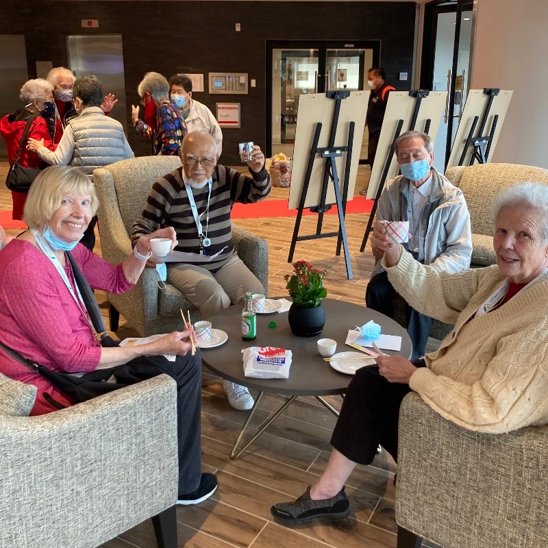 A gathering of seniors having snacks