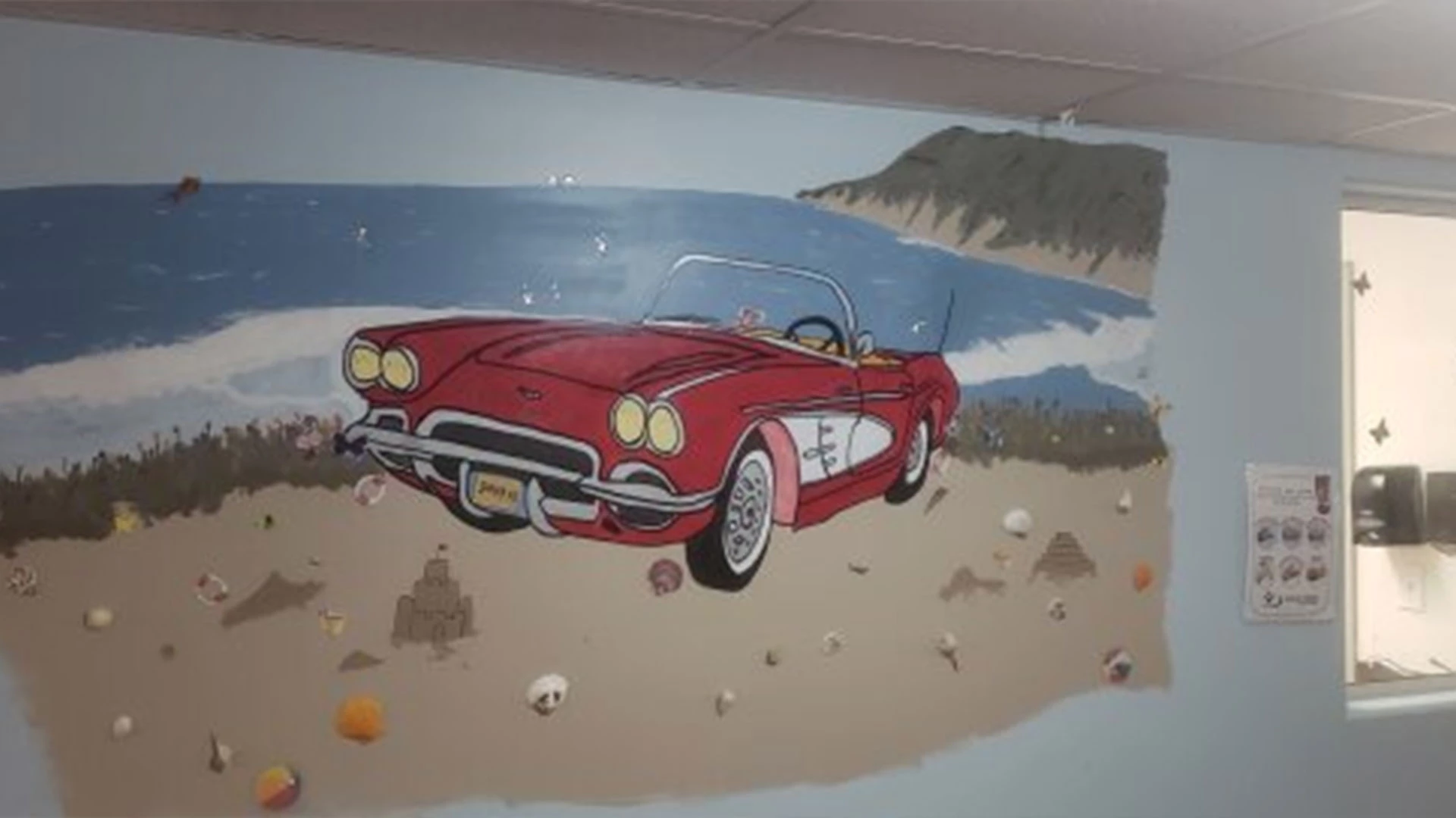 Painting of an old corvette on the wall