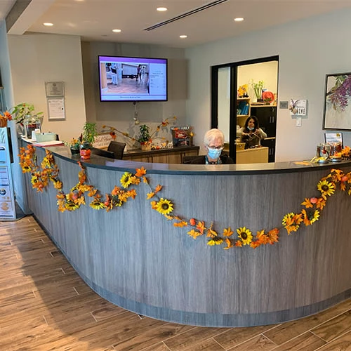 Wisteria Place's secretary desk decorated for the fall with beautiful flowers across the desk.