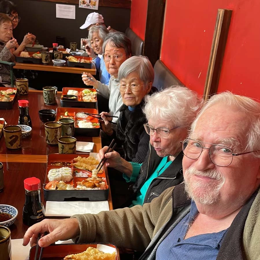 Some seniors enjoying Japanese Bento Boxes together