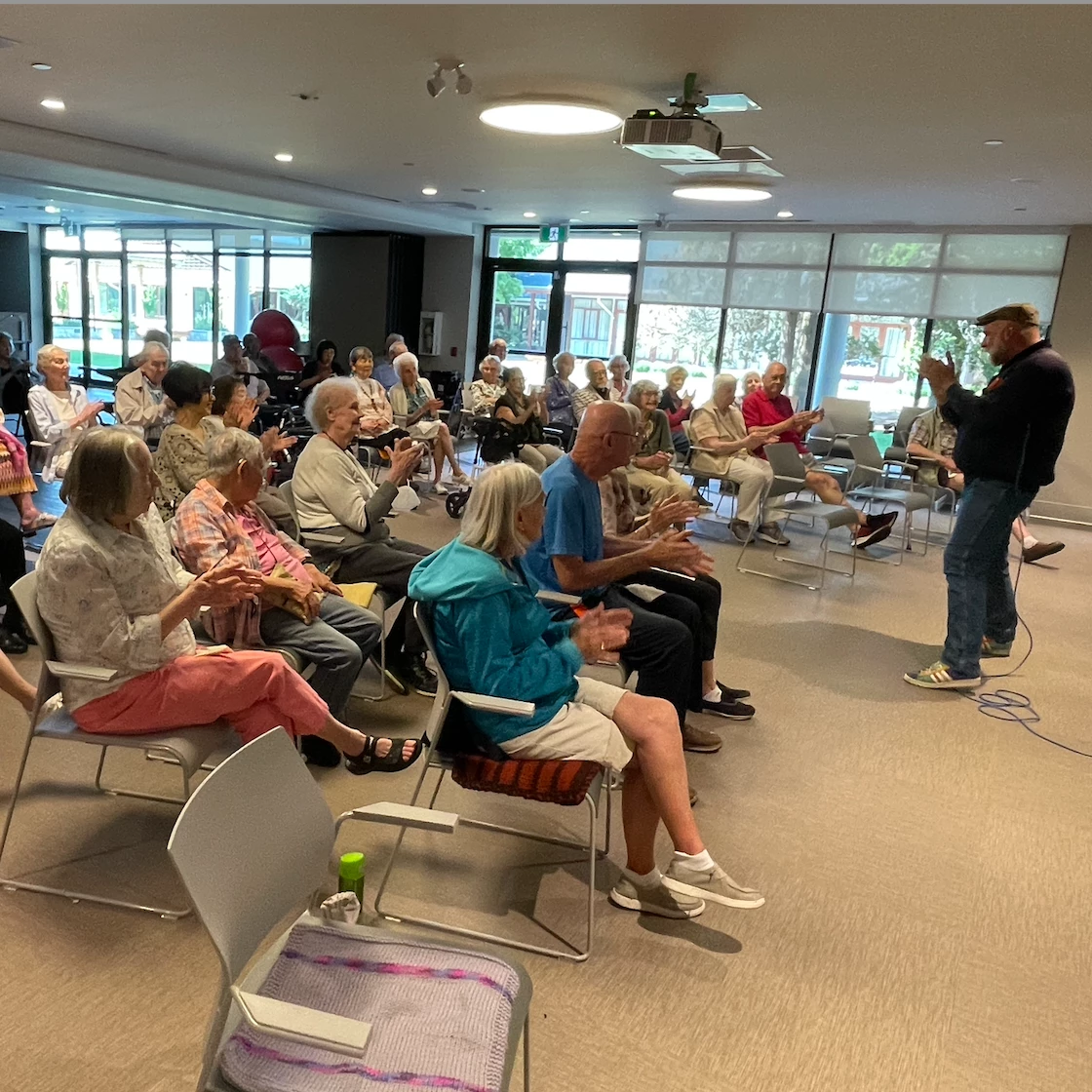 Seniors seated listening to a performance