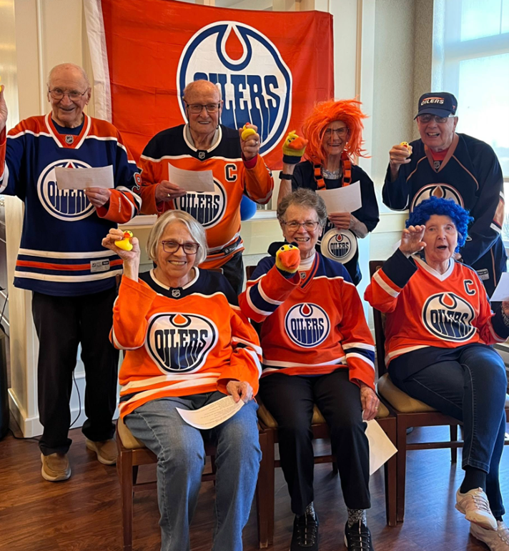Seniors at Everitt Gardens by Optima Living wearing Oilers jerseys to celebrate playoffs